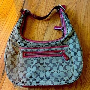 Coach bag in used condition.  Classic canvas with red leather detailing.